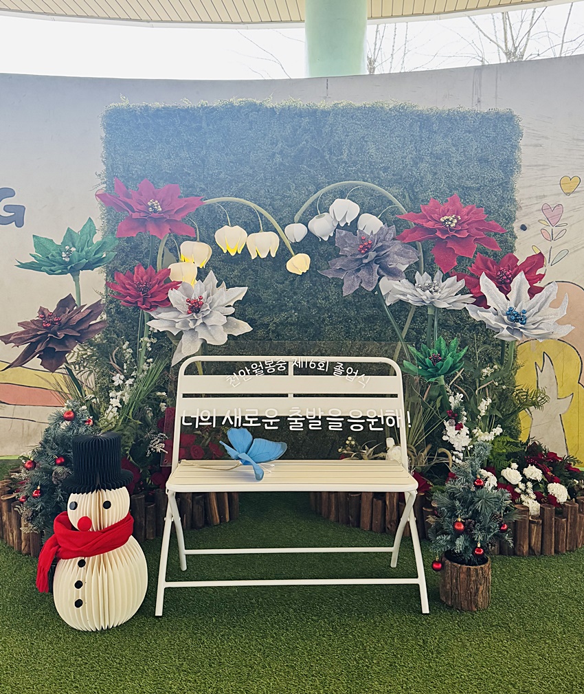 Floral photo zone and plant decor installed for a graduation ceremony